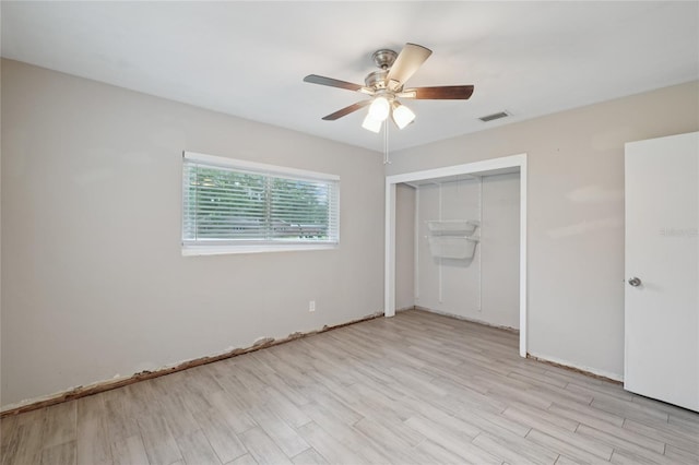 1712 Robin Hood Ln, Clearwater, FL 33764 - unfurnished bedroom with light wood-style flooring, a closet, and a ceiling fan