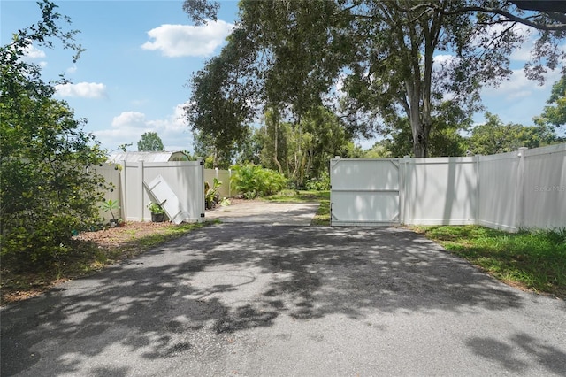 1712 Robin Hood Ln, Clearwater, FL 33764 - view of asphalt driveway featuring a gated entry