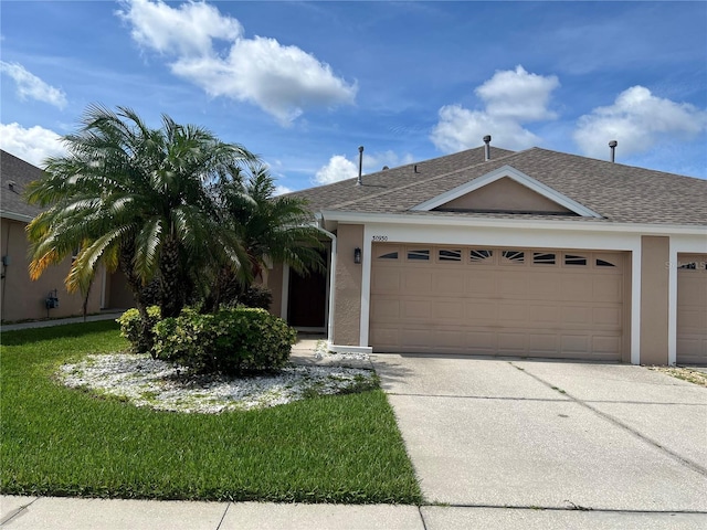 30930 Whitlock Dr, Wesley Chapel, FL 33543 - ranch-style home with a garage, concrete driveway, stucco siding, a shingled roof, and a front lawn