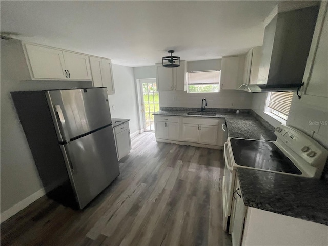1225 Nemeth St, Auburndale, FL 33823 - kitchen with freestanding refrigerator, white electric stove, dark wood finished floors, and white cabinetry