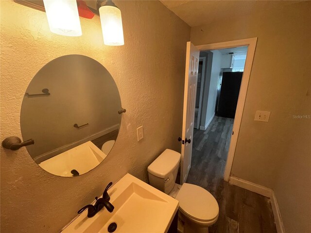 1225 Nemeth St, Auburndale, FL 33823 - bathroom featuring wood finished floors, a textured wall, and vanity