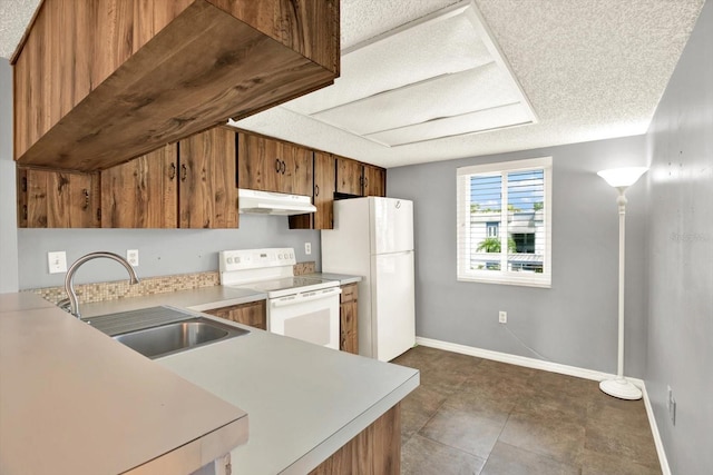 250 Cypress Ln, Oldsmar, FL 34677 - kitchen featuring under cabinet range hood, white appliances, light countertops, brown cabinetry, and a textured ceiling
