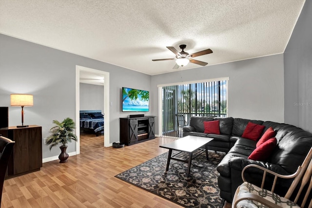 250 Cypress Ln, Oldsmar, FL 34677 - living room with a ceiling fan, wood finished floors, and a textured ceiling