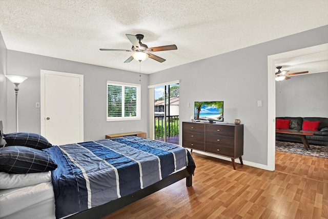 250 Cypress Ln, Oldsmar, FL 34677 - bedroom with access to exterior, light wood-style floors, ceiling fan, and a textured ceiling