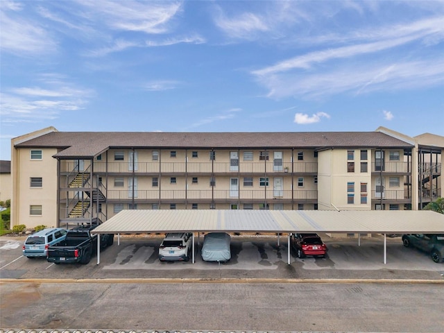 5245 Amulet Dr Unit 201, New Port Richey, FL 34652 - view of apartment building / complex featuring covered and uncovered parking and stairway