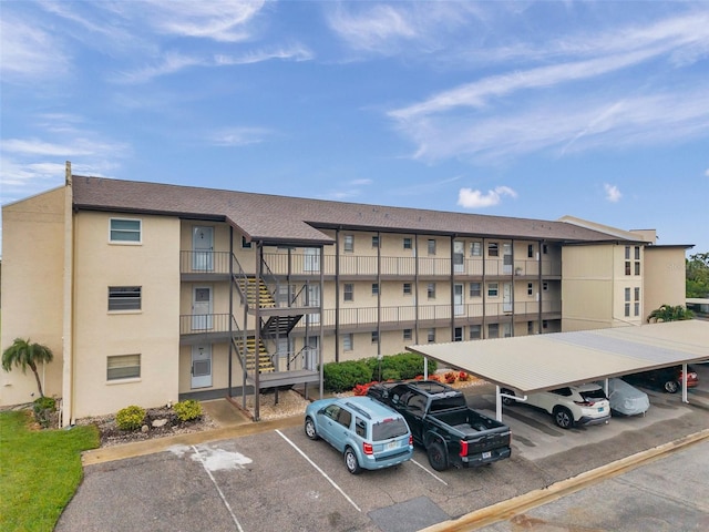 5245 Amulet Dr Unit 201, New Port Richey, FL 34652 - view of apartment building / complex with covered and uncovered parking and stairs