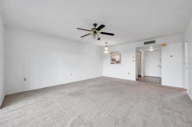 5245 Amulet Dr Unit 201, New Port Richey, FL 34652 - unfurnished living room featuring carpet floors and a ceiling fan