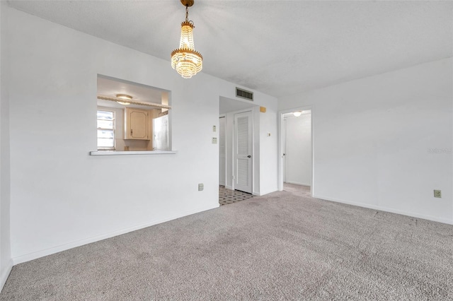 5245 Amulet Dr Unit 201, New Port Richey, FL 34652 - spare room featuring carpet and a chandelier