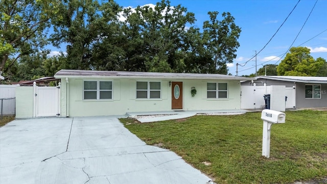 1712 W Atkinson St, Tampa, FL 33604 - ranch-style home featuring a gate, driveway, and stucco siding