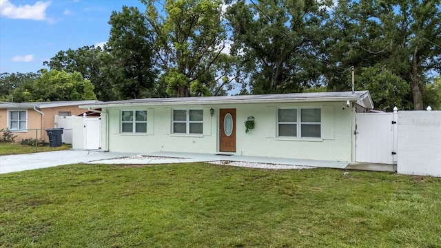 1712 W Atkinson St, Tampa, FL 33604 - ranch-style house featuring a gate and stucco siding