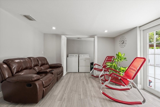 1712 W Atkinson St, Tampa, FL 33604 - living room featuring washing machine and dryer, light wood-style flooring, and recessed lighting