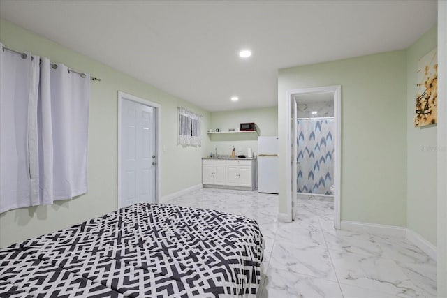 1712 W Atkinson St, Tampa, FL 33604 - bedroom featuring freestanding refrigerator, recessed lighting, light marble finish floors, ensuite bathroom, and bar area