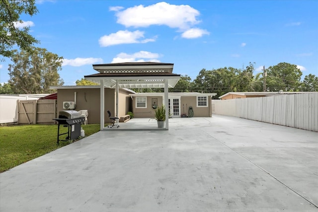 1712 W Atkinson St, Tampa, FL 33604 - rear view of property with stucco siding, concrete driveway, and a patio