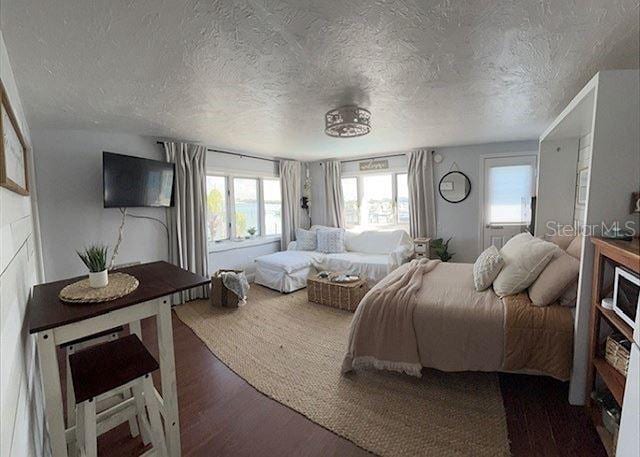 483 E Shore Dr Unit B4, Clearwater Beach, FL 33767 - bedroom featuring a textured ceiling and wood finished floors