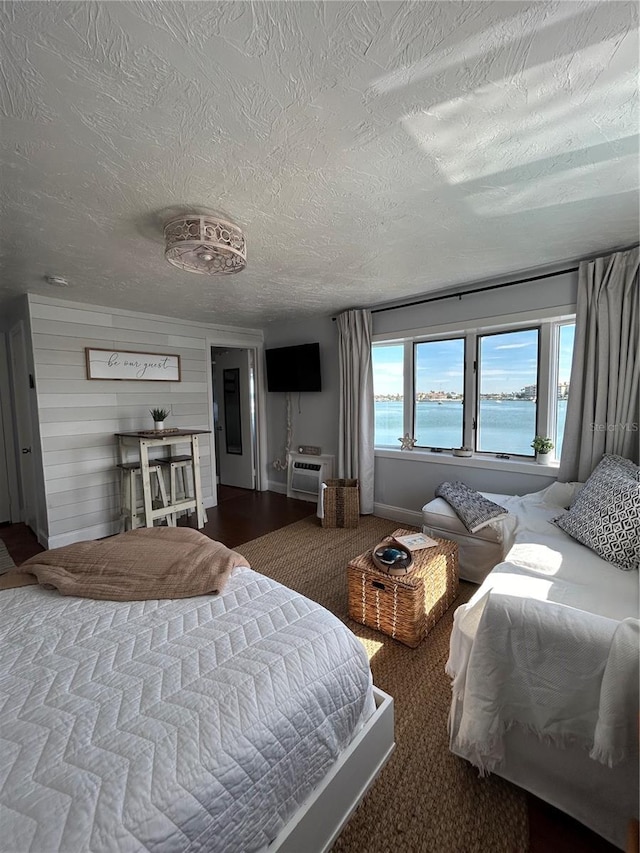 483 E Shore Dr Unit B4, Clearwater Beach, FL 33767 - bedroom with a textured ceiling and a wall unit AC