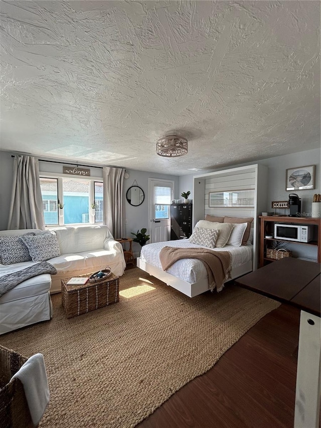 483 E Shore Dr Unit B4, Clearwater Beach, FL 33767 - bedroom featuring wood finished floors and a textured ceiling