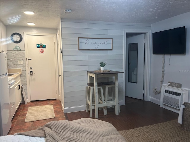 483 E Shore Dr Unit B4, Clearwater Beach, FL 33767 - kitchen with a textured ceiling, dark wood-style floors, and a wall mounted AC