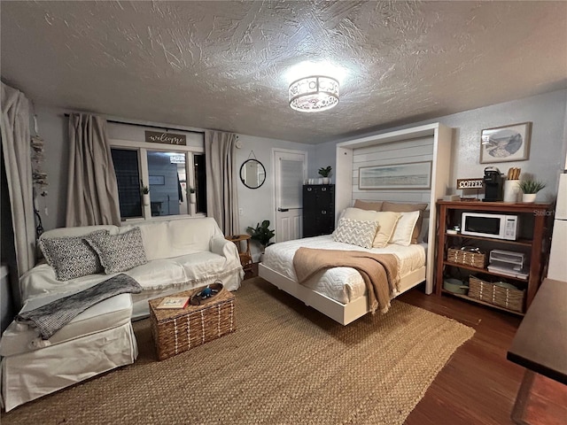 483 E Shore Dr Unit B4, Clearwater Beach, FL 33767 - bedroom featuring dark wood-style flooring and a textured ceiling