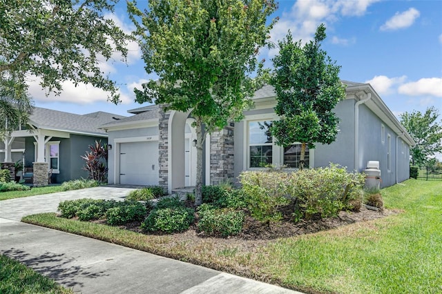 5434 Silver Sun Dr, Apollo Beach, FL 33572 - obstructed view of property featuring driveway, an attached garage, stucco siding, and a front yard