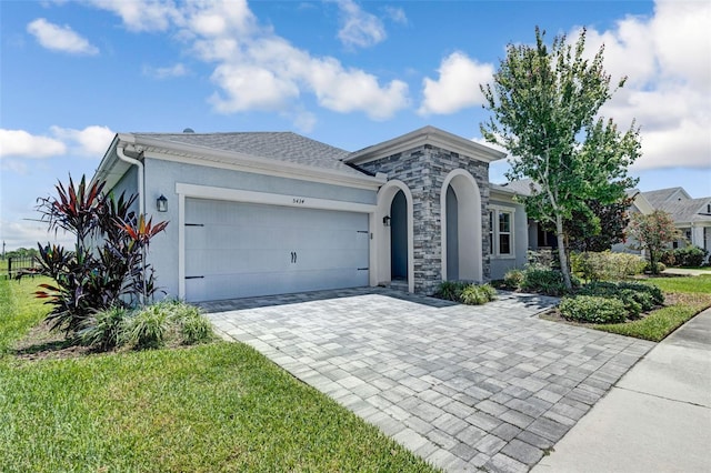 5434 Silver Sun Dr, Apollo Beach, FL 33572 - view of front of house featuring stucco siding, an attached garage, and decorative driveway