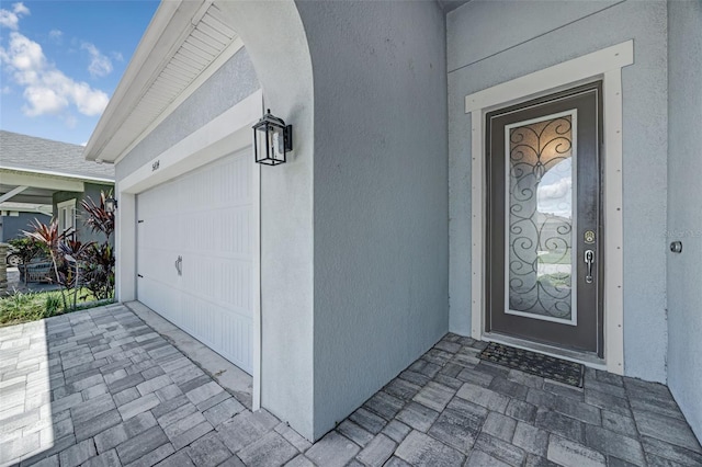 5434 Silver Sun Dr, Apollo Beach, FL 33572 - property entrance with stucco siding and a garage