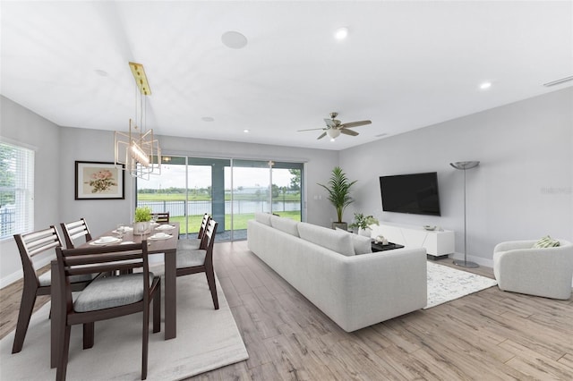 5434 Silver Sun Dr, Apollo Beach, FL 33572 - living room featuring light wood-type flooring, plenty of natural light, a ceiling fan, and recessed lighting