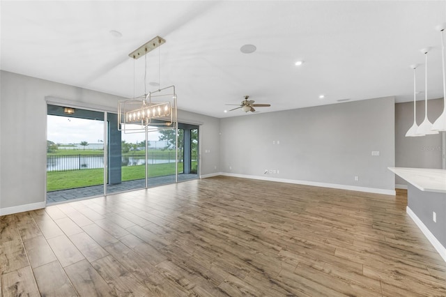 5434 Silver Sun Dr, Apollo Beach, FL 33572 - unfurnished living room featuring healthy amount of natural light, ceiling fan, wood finished floors, and recessed lighting
