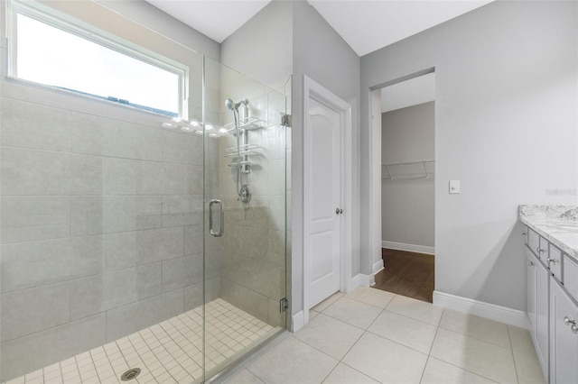 5434 Silver Sun Dr, Apollo Beach, FL 33572 - bathroom featuring vanity, a shower stall, tile patterned flooring, and a walk in closet
