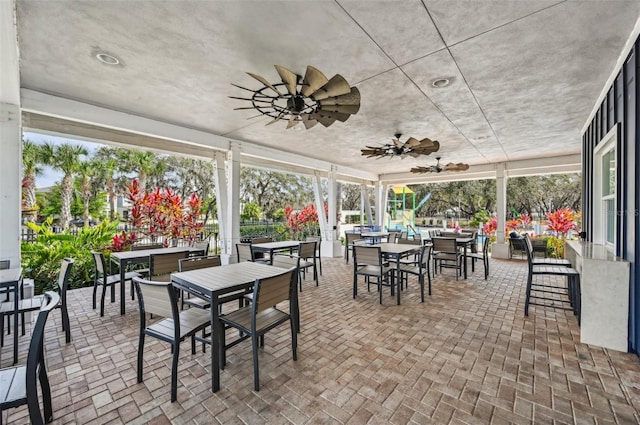 13008 Majestic Garden Ln, Riverview, FL 33579 - sunroom / solarium featuring outdoor dining area, ceiling fan, and brick patterned flooring