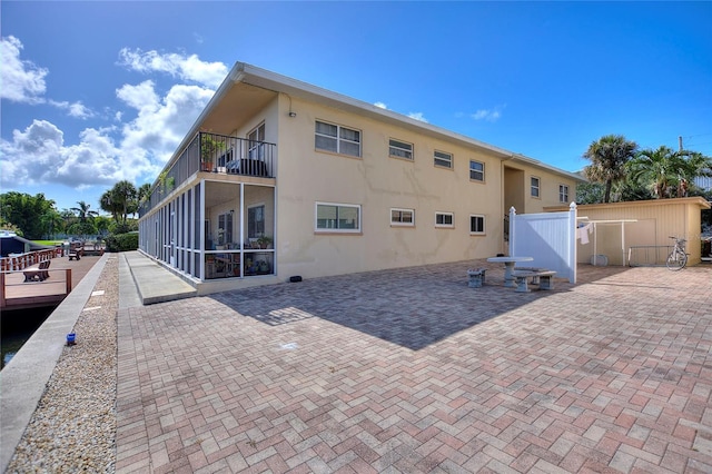 3753 46th Ave S Unit 10, Saint Petersburg, FL 33711 - rear view of property featuring a balcony, a patio area, and stucco siding