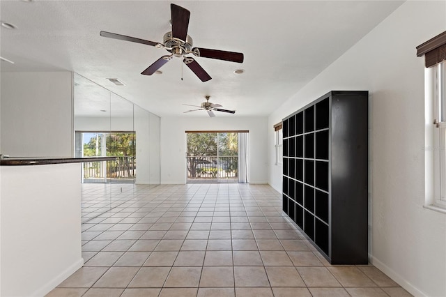 3753 46th Ave S Unit 10, Saint Petersburg, FL 33711 - empty room with healthy amount of natural light, light tile patterned floors, and ceiling fan