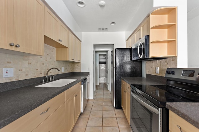 3753 46th Ave S Unit 10, Saint Petersburg, FL 33711 - kitchen featuring appliances with stainless steel finishes, light brown cabinetry, and dark countertops