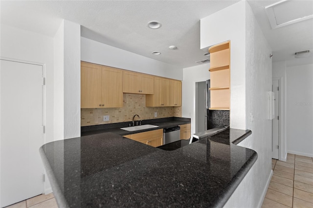 3753 46th Ave S Unit 10, Saint Petersburg, FL 33711 - kitchen with light brown cabinetry, light tile patterned floors, stainless steel dishwasher, backsplash, and a peninsula