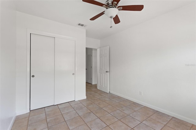 3753 46th Ave S Unit 10, Saint Petersburg, FL 33711 - unfurnished bedroom with a closet, light tile patterned floors, and a ceiling fan