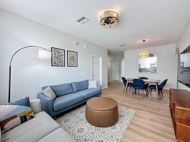 2300 Butterfly Palm Way Unit 204, Kissimmee, FL 34747 - living area with light wood-style flooring and baseboards
