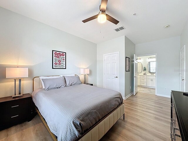 2300 Butterfly Palm Way Unit 204, Kissimmee, FL 34747 - bedroom with light wood-style flooring, ensuite bathroom, and ceiling fan