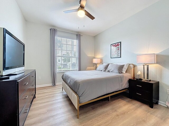 2300 Butterfly Palm Way Unit 204, Kissimmee, FL 34747 - bedroom featuring light wood finished floors and ceiling fan