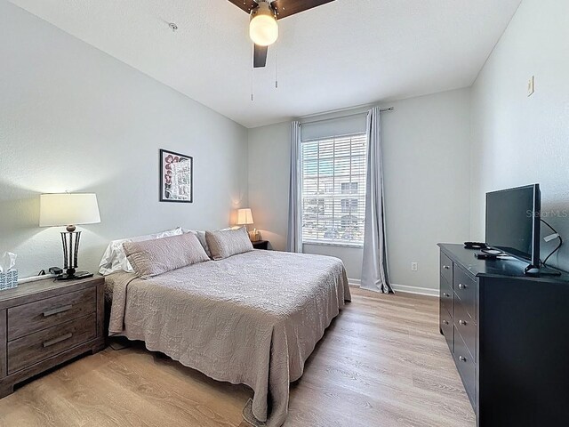 2300 Butterfly Palm Way Unit 204, Kissimmee, FL 34747 - bedroom with light wood-style flooring and a ceiling fan