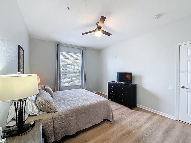 2300 Butterfly Palm Way Unit 204, Kissimmee, FL 34747 - bedroom with light wood-type flooring and ceiling fan