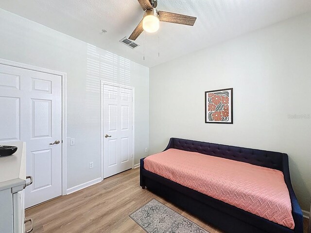 2300 Butterfly Palm Way Unit 204, Kissimmee, FL 34747 - bedroom with light wood finished floors and ceiling fan