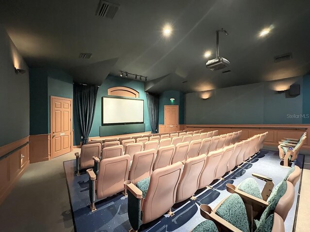 2300 Butterfly Palm Way Unit 204, Kissimmee, FL 34747 - carpeted cinema room featuring track lighting, a decorative wall, and wainscoting