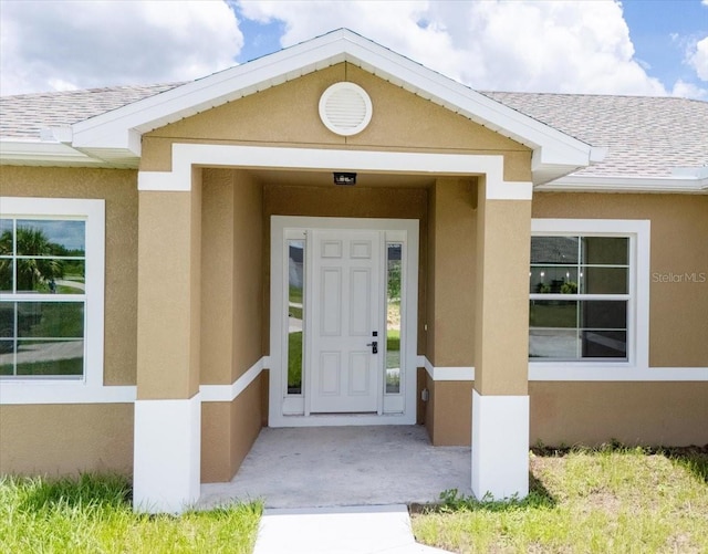 437 Mercedes Ct, Lehigh Acres, FL 33972 - property entrance featuring stucco siding and roof with shingles