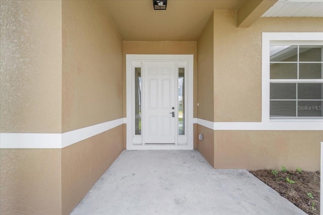 437 Mercedes Ct, Lehigh Acres, FL 33972 - doorway to property with stucco siding