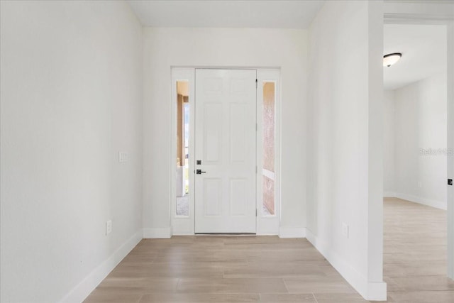 437 Mercedes Ct, Lehigh Acres, FL 33972 - foyer with baseboards and light wood-style floors