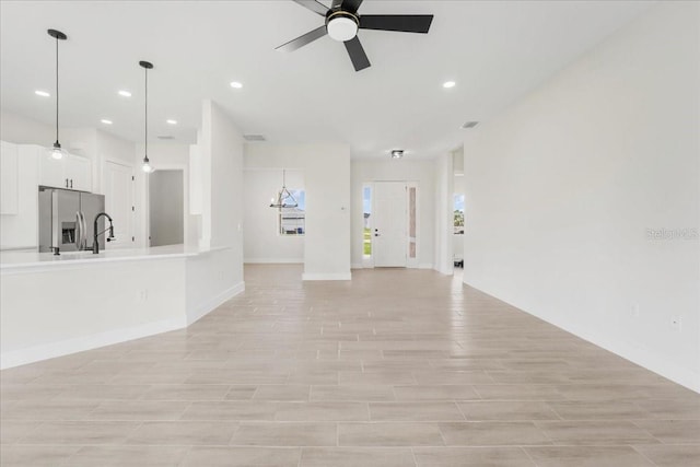 437 Mercedes Ct, Lehigh Acres, FL 33972 - unfurnished living room featuring ceiling fan and recessed lighting