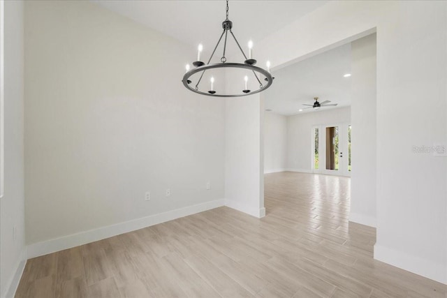 437 Mercedes Ct, Lehigh Acres, FL 33972 - empty room featuring a chandelier, a ceiling fan, and light wood finished floors