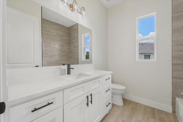 437 Mercedes Ct, Lehigh Acres, FL 33972 - bathroom with vanity, healthy amount of natural light, and a tub to relax in