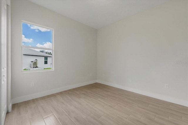437 Mercedes Ct, Lehigh Acres, FL 33972 - unfurnished room featuring wood tiled floors and baseboards