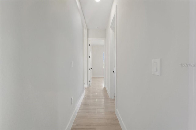 437 Mercedes Ct, Lehigh Acres, FL 33972 - corridor with baseboards and light wood-style flooring