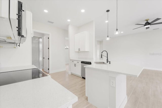 437 Mercedes Ct, Lehigh Acres, FL 33972 - kitchen featuring dishwasher, a peninsula, light wood-style flooring, light countertops, and recessed lighting